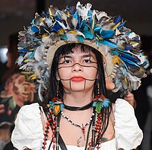 Front view of Suruí in headdress and white dress