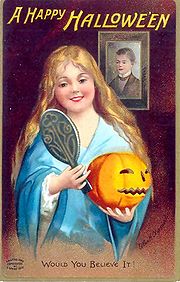 In this Halloween greeting card from 1904, divination is depicted: the young woman looking into a mirror in a darkened room hopes to catch a glimpse of the face of her future husband.