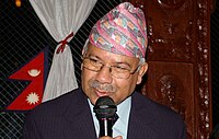 Madhav Kumar Nepal, bespectacled and mustachioed, speaking into a microphone