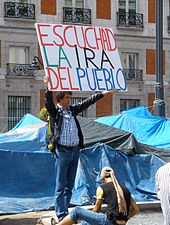 "Hear the wrath of the people", a member of the Indignados, a Spanish left-wing populist movement, in Puerta del Sol, 2011 Madrid - Acampada Sol 2011 43.JPG