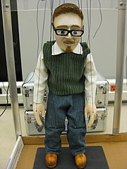 A robot-manipulated marionette, with complex control systems