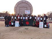 Students holding placards in front of "Texas Tech University" sign