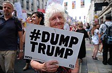Protester on July 13, 2017, at Trafalgar Square, London. The sign refers to online protests, i.e. hashtags. Dump Trump ! (42730120094).jpg
