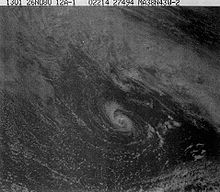 A satellite photo showing a small hurricane, there are a lot of clouds surrounding it