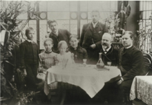 A group photograph of the Weber family around a table