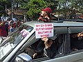 Protesters in a vehicle with anti-military slogans