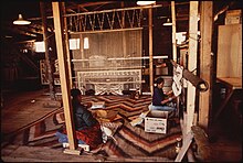 The art of Dine weaving is part of the traditional knowledge of the Navajo people. NAVAJO WOMEN WEAVE A RUG AT THE HUBBEL TRADING POST, FIRST TRADING POST ON THE NAVAJO RESERVATION - NARA - 544416.jpg