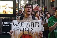 A protester at an Occupy Wall Street protest, an American movement against economic inequality and corporate greed from 2011. We Are The 99%25.jpg