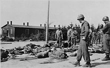 US soldiers view the corpses of prisoners which lie strewn along the road in the newly liberated Ohrdruf concentration camp. Buchenwald Ohrdruf Corpses 76501.jpg