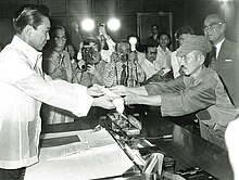 Japanese soldier Hiroo Onoda offering his military sword to Philippine President Ferdinand Marcos on the day of his surrender, 11 March 1974 President Marcos and Hiroo Onoda.jpg