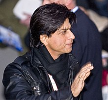 Shah Rukh Khan waving to fans at a film festival