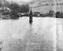 The church tower of Derwent slowly disappearing below the water as the reservoir was filled in 1946 Church tower at Ladybower Reservoir.png
