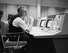 NASA chief flight director Gene Kranz at his console on May 30, 1965, in the Mission Operations Control Room, Mission Control Center, Houston. Eugene F. Kranz at his console at the NASA Mission Control Center.jpg