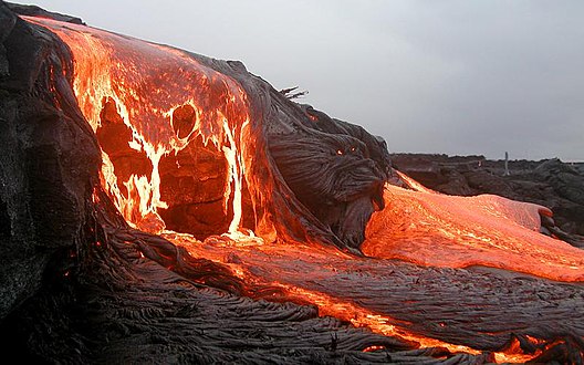 Molten lava flowing onto a beach, a fitting inspiration for a fire type Pokémon.