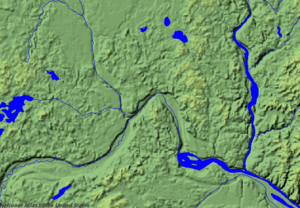 This shaded relief image shows the area of Minneapolis-St. Paul. The wide channel of River Warren enters the image from the southwest. The Mississippi enters from the north near the left side and the St. Croix enters from the north at the right. The present rivers are grossly underfit for their valleys; the widening of the Mississippi to the southeast is the slackwater pool from Lock and Dam No. 2. MSP geology.gif