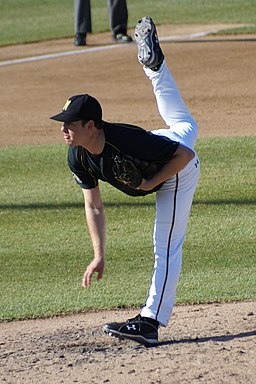 NCAA pitcher with foot above head