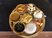 A dal-bhat thali with boiled rice, lentil soup, fried leafy greens, vegetable curry, yoghurt, papad and vegetable salad Nepali dal-bhat-tarkari.jpg