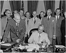 President Truman signs the National Security Act Amendment of 1949 Photograph of President Truman at his desk in the Oval Office, signing the National Security Act Amendments of 1949... - NARA - 200168.jpg