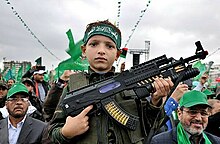 A child with a toy gun in the 25th anniversary of Hamas 25th anniversary of Hamas (18).jpg