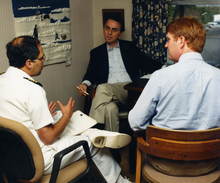 Sagan (center) speaks with CDC employees in 1988. Carl Sagan with two CDC employees.png