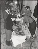 Mud Angels cleaning pages in the Florence railway station, 1966