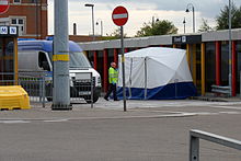 Police forensic investigation in Ashton-under-Lyne, England, using a tent to protect the crime scene England-forensic2.jpg