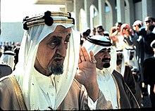 King Faisal salutes a group of soldiers