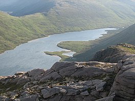 A view of a lake looking down from a mountain top