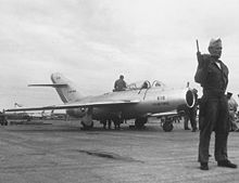 Repainted in USAF markings and insignia, the MiG-15b is under guard and awaiting flight-testing at Okinawa. MiG-15bis Kimpo Sep 1953.jpeg