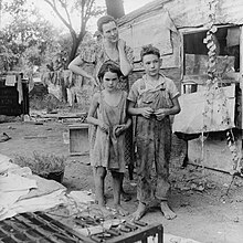An impoverished American family living in a shanty during the Great Depression. Photographed by Dorothea Lange in 1936 Poor mother and children, Oklahoma, 1936 by Dorothea Lange.jpg