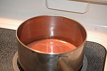 Reduction of red wine for a sauce by cooking it on a stovetop. It is called a reduction because the heat boils off some of the water and most of the more volatile alcohol, leaving a more concentrated, wine-flavoured sauce. Reduction du vin rouge.jpg