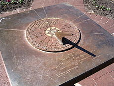 Southern-hemisphere sundial in Perth, Australia. Magnify to see that the hour marks run anticlockwise. Note graph above the gnomon of the Equation of Time, needed to correct sundial readings. Sundial in Supreme Court Gardens, Perth.jpg