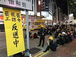 Strikers near the Sogo Department Store on Yee Wo Street. Closed in solidarity with the general strike action.