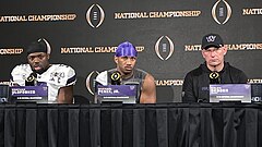 Football players and coaches giving a press conference