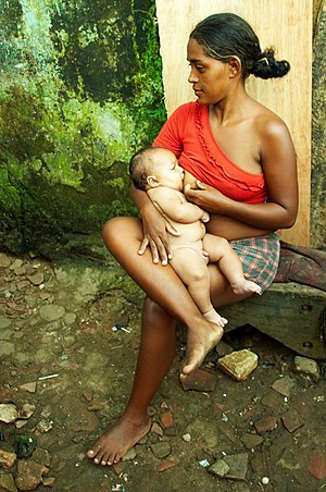 A woman breastfeeding in the Favela do Maruim,...