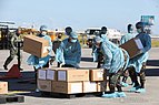 Работници разтоварват кутии с медицински консумативи в авиобаза Виламор