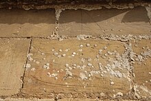 Graffito of a ship damaged by lichen