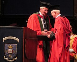 Australian medic Ian D. Cooke (right) wearing a doctoral gown at graduation ceremony Ian Cooke HC1.jpg