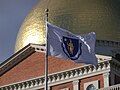 Massachusetts flag in front of the state house