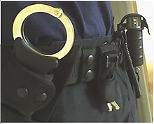 A British police officer's duty belt, with Hiatts Speedcuffs, handcuff keys and CS spray visible. Police Duty Belt.jpg