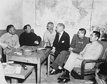 Mao Zedong (second from left in a dark uniform) and Chinese Communist Party (CCP) officials meeting with United States Ambassador to China, Patrick Hurley (at center - in bow tie), at CCP headquarters in Yan'an, 1945. 1945 Conference between Communists and Americans in Yan'an - NARA - 531400.jpg