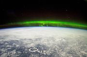 The Aurora Borealis as viewed from the ISS Expedition 6 team. Lake Manicouagan is visible to the bottom left.
