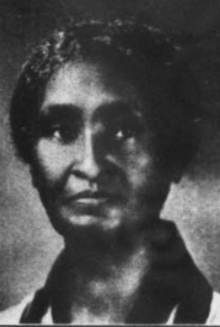 A Black woman wearing a collared top