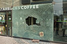 A front window of a Starbucks coffee shop damaged in the 2010 G20 Toronto summit protests G-20 Toronto June 2010 (15).jpg