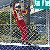 Hélio Castroneves climbs the fence to celebrate his win in 2012