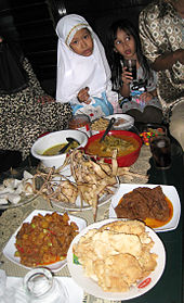 During Idul Fitri, families get together to enjoy a lebaran feast where ketupat and various special dishes are served. Hidangan Lebaran.JPG