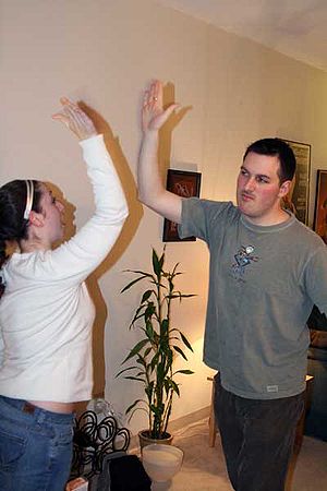 A woman and a man performing a high five.