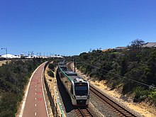 Electric passenger train viewed from bridge