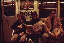 SUBWAY RIDERS LOST IN THEIR OWN THOUGHTS AND READING THE NEWSPAPER ON THE LEXINGTON AVENUE LINE OF THE NEW YORK CITY... - NARA - 556666.jpg