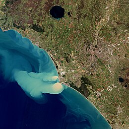 River discharging sediment into the ocean Sediment plume at sea.jpg